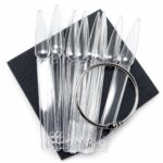 Clear plastic pipettes fanned out on a dark square background, with a silver circular ring resting over them.
