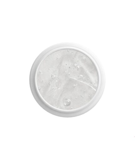 Top-down view of a white circular jar lid filled with clear liquid and ice chunks.