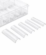 Six clear 1.5 mL microcentrifuge tubes with graduated marks laid in a row near a transparent rack.