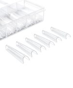 Clear plastic pill organizer with divided compartments and six detachable curved sleeves laid out nearby