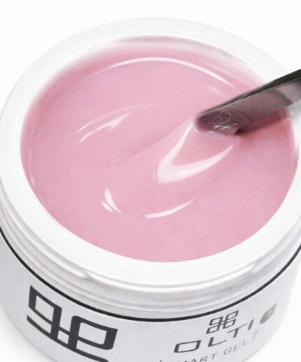 Pink gel nail polish in a white container, with a brush resting on the surface and swirling the pink liquid.