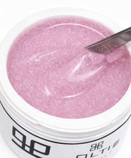 Pink glitter nail gel in an open jar with a metal spatula resting on the surface featureless white background.