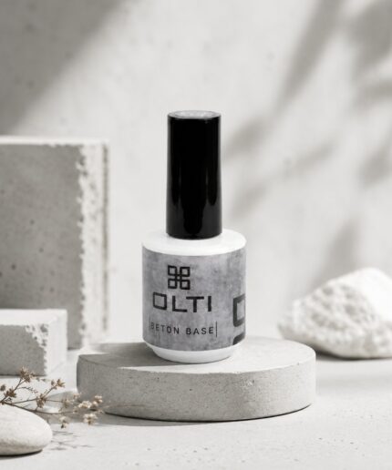 White nail polish bottle with a tall black cap labeled OLTI Beton Base on a circular concrete pedestal.