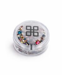 Clear round jar filled with multicolored rhinestones for nail art