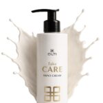 White pump bottle labeled 'OLTI Take CARE Hand Cream' with a cream splash backdrop, illustrating product packaging for skincare.