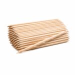 Pile of natural wood pencils stacked in parallel with sharpened tips on a white background, one pencil resting across the front.
