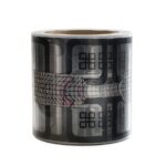 Decorative black and gray washi tape roll with abstract geometric patterns wrapped around the surface