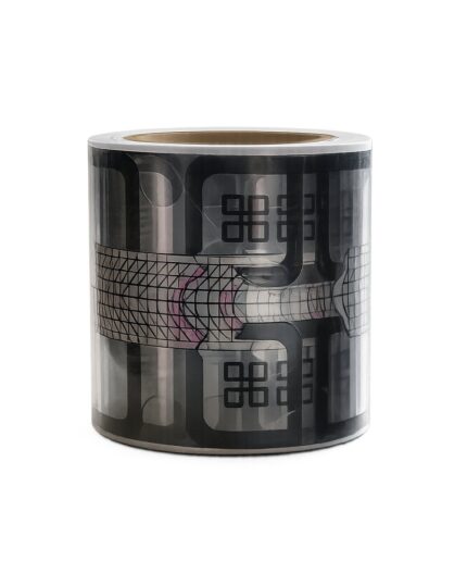 Decorative black and gray washi tape roll with abstract geometric patterns wrapped around the surface