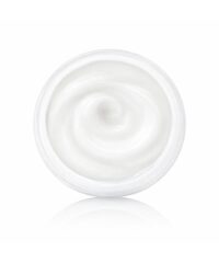 Top-down view of a clear jar filled with smooth white cream, swirl pattern visible in the center